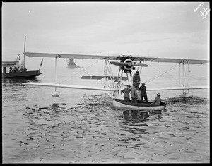 Seaplane from SS Ile de France lands mail in Boston Harbor after leaving the liner 300 miles off Nova Scotia and landing 10 hours later, saving 30 hours. Deer Island light in background.