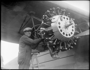 Man working on plane engine
