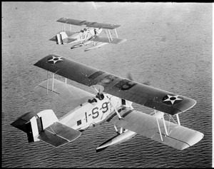 Military sea planes in flight over water