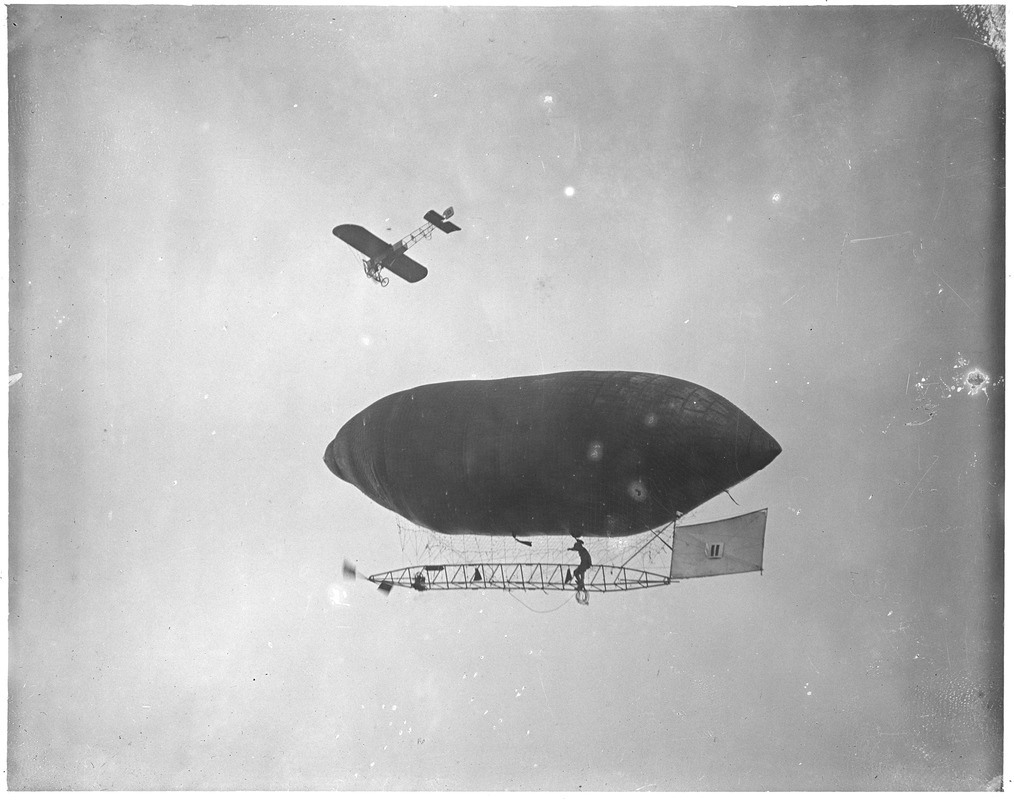 Man-powered balloon and monoplane in air at Squantum, Harvard-Boston Aero-meet