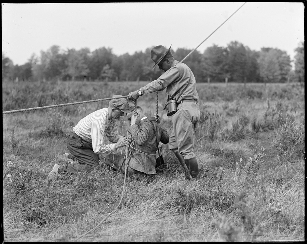 Tieing a photographer to man-kite ropes at Fort Devens