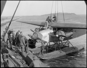 Byrd's South Pole plane being launched off East Boston Airport. Governors Island in back, people.