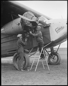Wilmer Stultz (right), Lew Gordon (left) working on the plane Friendship. I. Gordon - machinist. W. Stultz - pilot of new Byrd Fokker to be used on South Pole trip. East Boston Airport.
