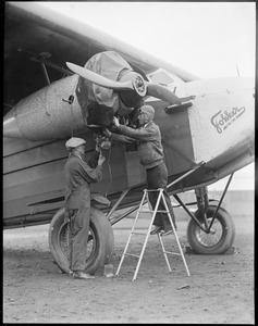 Wilmer Stultz - pilot of Byrd's South Pole plane on right. Lew Gordon - machinist on left. Plane: Friendship. East Boston Airport.
