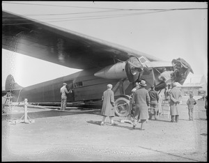 Byrd's South Pole plane being weather-proofed with Berryloid. Plane had been flown over by Amelia Earhart and Schultz.