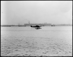 Byrd's South Pole plane lands for first time in Boston Harbor with new steel pontoons. They weigh 1300 pounds more than the wheels.