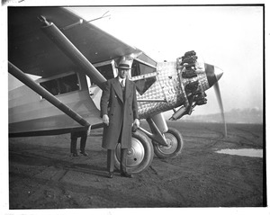 Lindy stands next to a similar plane to Spirit of St. Louis at East Boston Airport.
