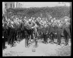 President Coolidge pins cross on Bremen flier Maj. Fitzmaurice in Washington D.C.