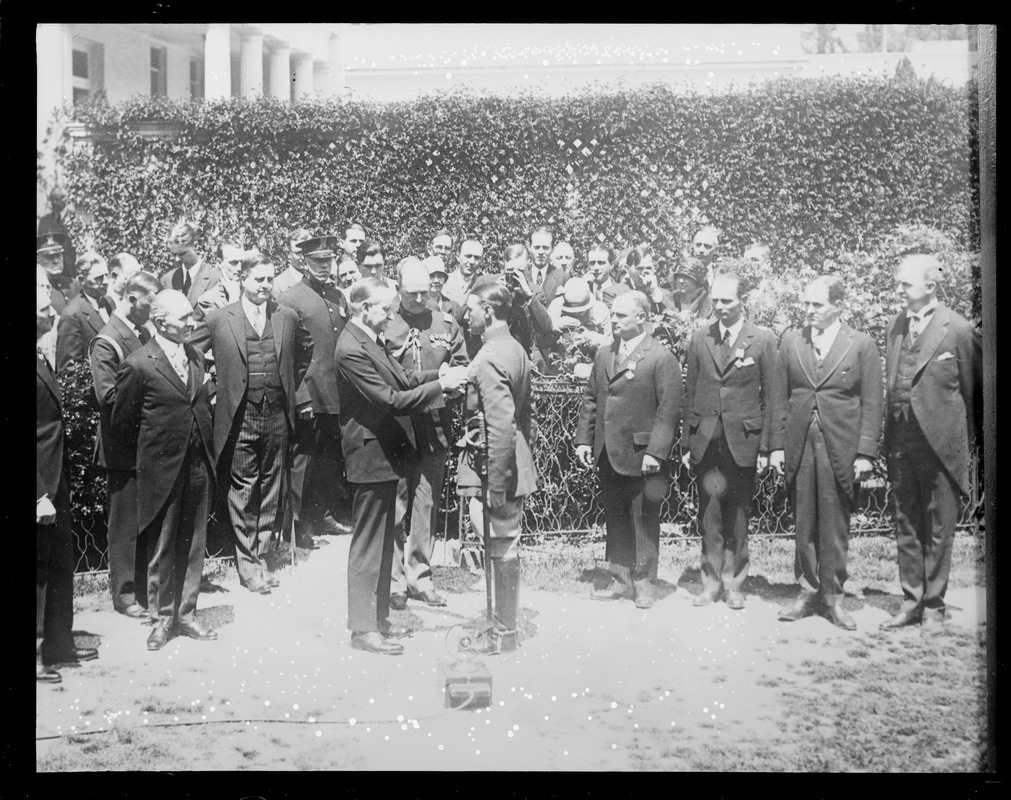 President Coolidge pins cross on Bremen flier Major Fitzmaurice in Washington D.C.