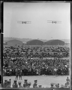 World Fliers East Boston airport the day they arrived. 2 in air, crowd. - hangars, etc.