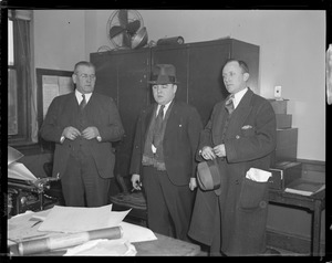 James "Skeets" Coyne (Middle) wanted in murder of Charlie "King" Solomon. Standing with Conye is Capt. Stephen J. Flaherty (I) and Sargent William J McCarthy, at Roxbury Crossing Station