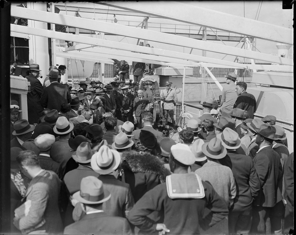 Sailors watch as Charles Ponzi is filmed on board the SS Vulcania on day of deportation