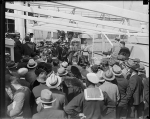 Sailors watch as Charles Ponzi is filmed on board the SS Vulcania on day of deportation