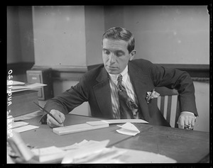 Charles Ponzi working at desk