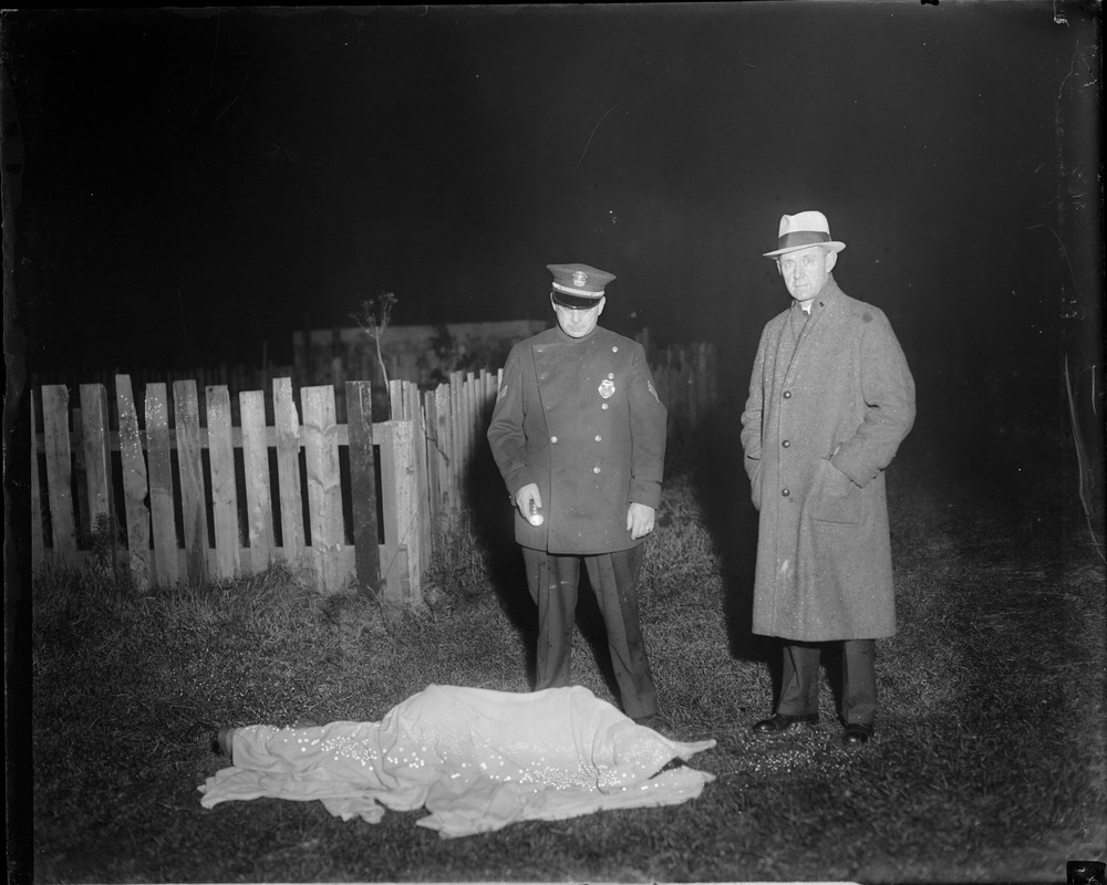 Officer and detective stand over body