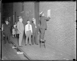 Police Commissioner Eugene Holtman and Superintendent Michael Crowley put up poster in Chinese warning Chinatown not to have a Tong war.