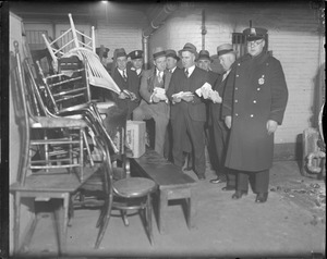 Police raiding squad inventory articles seized during raid at One Boylston St., race track bookmaker's quarters.