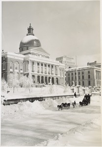 Family rides dog sled past State House on Beacon St., after 13'' snowfall