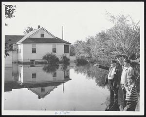 This Used to be Home, Robert Kirby, 8, says of the water-surrounded house at 26 Helena St., Dedham. He is showing the damage to Red Cross workers William C. Dolan (left) and Donald H. Waugh.