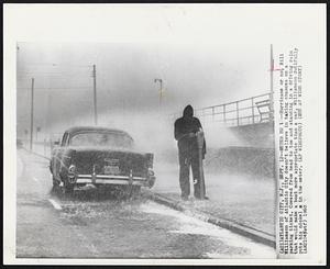 Meter Ho!--Hurricane or no, Bill Williamson of Atlantic City doesn't believe in taking chances on a parking ticket. Covered from head to toe and standing in a driving rain that would make a boat more appropriate than a car, Williamson dutifully puts his nickel in the meter.