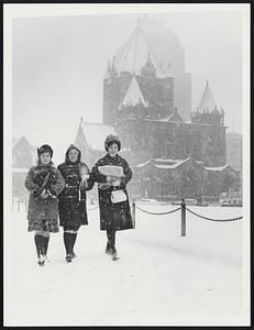 Stormy School Day - Protecting their books, Boston University students (from left) Ruth Sawyer, Ann Myerson and Pam Bruchac walk through snow in Copley Square. In background, Trinity Church.