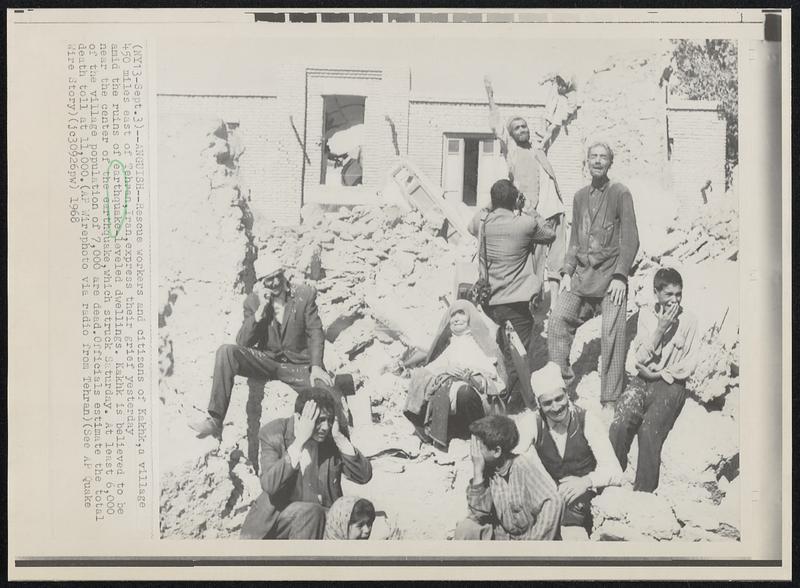 Anguish--Rescue workers and citizens of Kakhk, a village 450 miles east of Tehran, Iran, express their grief yesterday amid the ruins of earthquake-leveled dwellings. Kakhk is believed to be near the center of the earthquake, which struck Saturday. At least 6,000 of the village population of 7,000 are dead. Officials estimate the total death toll at 11,000.