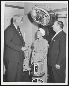Boston City Hospital Gets Ready for any storm casualties. Here Dr. John F. Conlin, superintendent (left), confers on emergency operating room equipment with Mary Lawless of Roxbury, supervisor of operating rooms, and Robert J. Cahalane of East Boston, in charge of security.