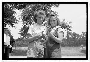 Two young women holding horseshoes