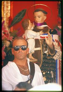 Boston - N. End 2002 - A man stands next to the statue of St. Anthony during the annual Feast