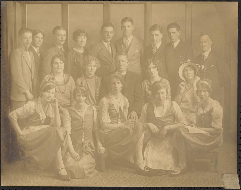 Young ladies and men with priest