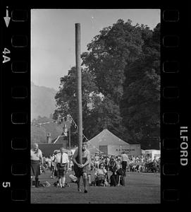 Man in kilt starts caber toss