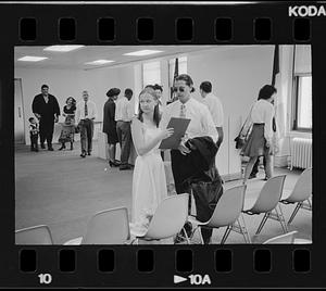 People wait at a government office, probably for civil wedding ceremonies