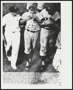 Double Trouble -- New York Yankee pitcher Jim Bouton is helped from the diamond in the 4th inning of tonight's game between the Yankees and the Baltimore Orioles. Bouton was felled by a vicious drive off the bat of the Orioles' Jack Brandt. The ball opened an 1 1/2-inch gash on his face and badly bruised his shoulder blade. Just last night, super star Mickey Mantle of the Yankees broke a small bone in his left foot during a game between the two teams and will be sidelined at least four weeks. Shown with Bouton are trainer Joe Soares, left, and an unidentified Yankee player.