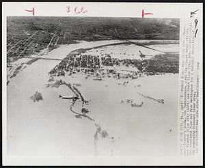 Truman Flies Over Sioux City -- President Truman's plane, the Independence, with him aboard wings its way over flooded Sioux City (left) and South Sioux City, Neb. (right) today. The President flew out from Washington for a personal inspection of the rampaging Missouri River area.