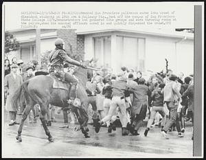 Mounted San Francisco policeman wades into crowd of dissident students at 19th Ave & Holloway Sts., just off the campus of San Francisco State College 12/9. Demonstrators had gathered into groups and were throwing rocks at the police, when the mounted officers moved in and quickly dispersed the crowd.