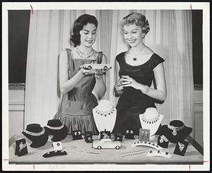 Diamonds may be a girl's best friend, but models Mary Gardiner (left) and Sandy Rosten seem to be more interested in the miniature Buick. The $3,000,000 collection of gems shown here will be displayed by Buick at the General Motors Motorama opening April 19 at Commonwealth Armory. Miss Rosten is wearing the famed Hope Diamond. The jewels are from the Harry Winston collection.