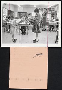 Growth Aided. Ten-year-old Kathy Dix, left, of Pikesville, Md., shares a reading lesson with Debra Mask, 8 right, in the 4th grade classroom at Scott's Branch elementary school in Baltimore, Md. Kathy, one of the nation's some 10,000 hypopituitary dwarfs, has had her growth helped by receiving hormone injections at Johns Hopkins Medical School under the supervision of Dr. Robert M. Blizzard, head of Pediatric Endrocrinology. When she began the injections two years ago, she was 36 inches 11, a foot shorter than a normal 8-year-old. Now Kathy is 42 inches tall--and still growing.