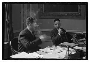 Two men seated at a desk