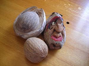 Coconuts, one whole, one split, one with carved