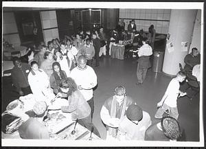 People in a buffet line, most likely at a special event