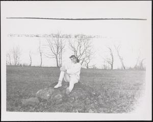 Young woman sitting on a rock