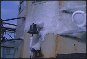 Bell on ship wall, surrounded by ice