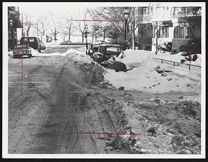 Stately Pinckney Street looks more like a used car lot since last weeks' storms. Abandoned cars, plus snow that couldn't be plowed because of their presence, narrow thorough-