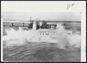 Huge Waves pound structures at Miami Beach (above and below left) yesterday during backlash of Atlantic storm that battered coast from Massachusetts to North Carolina. Being hit above is restaurant and lighthouse with Collins Ave. bridge in background. Seas below hammer seawall and cabana lounges at a beach hotel. In photo (below, right) trailer homes at Long Beach Island, N. J. lie strewn like driftwood after floods swirled through the area during the rampaging northeaster.