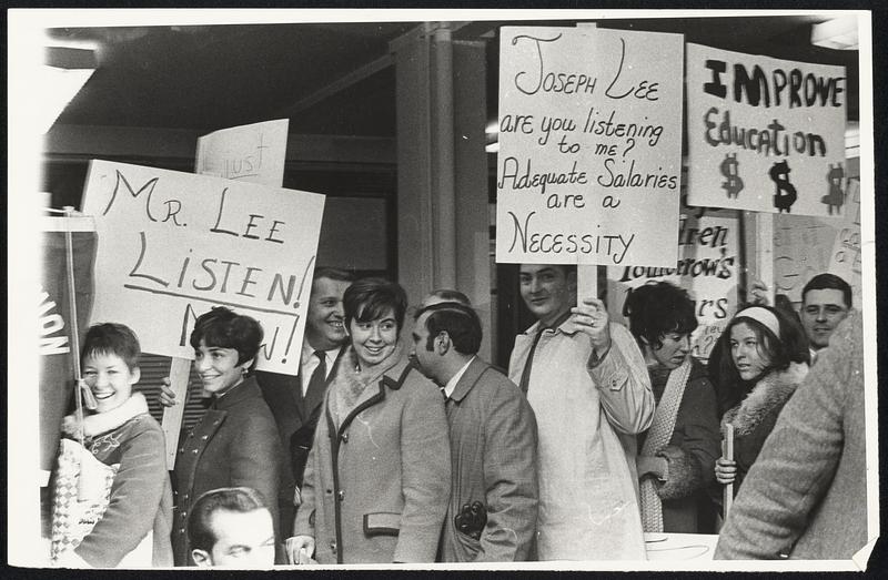 Picketing Boston teachers march in front of School Committee headquarters.