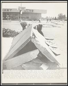 Two boys look under a section of buckles concrete in downtown Sylmar, Calif., about 20 miles north of downtown Los Angeles. The pavement buckled as a result of shifting earth during the massive earthquake that hit the Southern California area early 2/9. At least 28 persons were known to have died as a result of the quake, which is the largest to hit the area in many years.