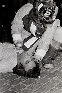 Firefighter John O'Driscoll tends to a patient during a medical aid call on Broadway