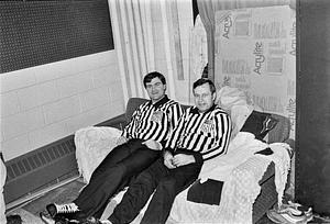 David "Murph" Murphy and unidentified man refereeing hockey game, in between periods