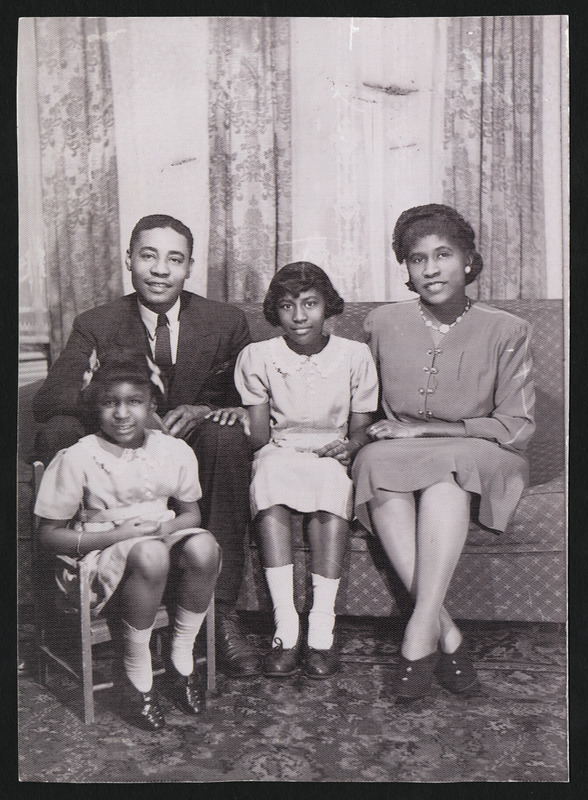 Brandford Burke, Keitha's father, Henrietta "Yetta" Burke (nee Brown), Keitha's mother, and Keitha Burke Hassell. Beverley Burke (Keitha's sister) on chair