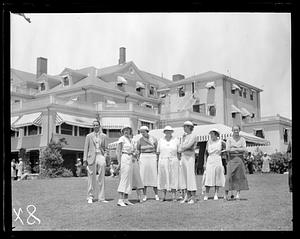 A group of golfers standing in front of the Brae Burn country club's club house